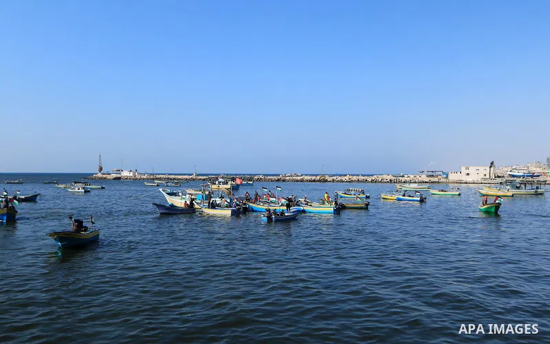 Palestinians ride fishing boats during a rally to break Israel's blockade on Gaza Strip, at the sea in Gaza City, on Aug. 11, 2018. Photo by Mahmoud Khattab