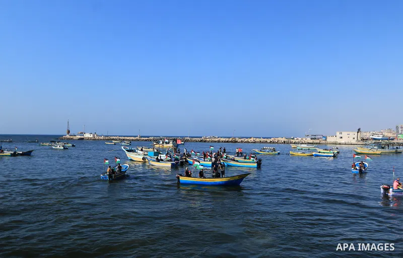 Palestinians ride fishing boats during a rally to break Israel's blockade on Gaza Strip, at the sea in Gaza City, on Aug. 11, 2018. Photo by Mahmoud Khattab