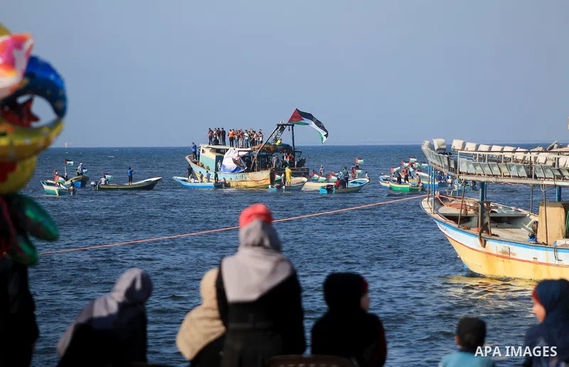 Palestinians ride fishing boats during a rally to break Israel's blockade on Gaza Strip, at the sea in Gaza City, on Aug. 11, 2018. Photo by Mahmoud Khattab