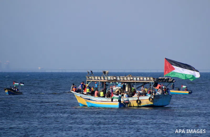 Palestinians ride fishing boats during a rally to break Israel's blockade on Gaza Strip, at the sea in Gaza City, on Aug. 11, 2018. Photo by Mahmoud Khattab