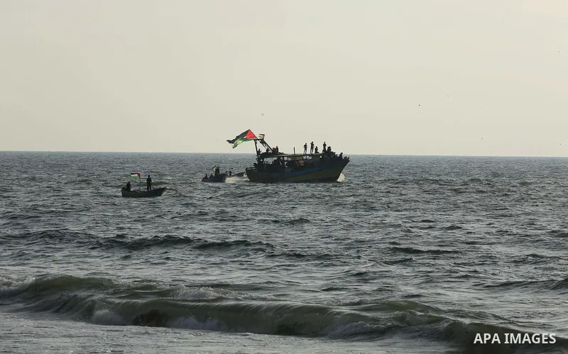 Palestinians ride fishing boats during a rally to break Israel's blockade on Gaza Strip, at the sea in Gaza City, on August 11, 2018. Photo by Dawoud Abo Alkas