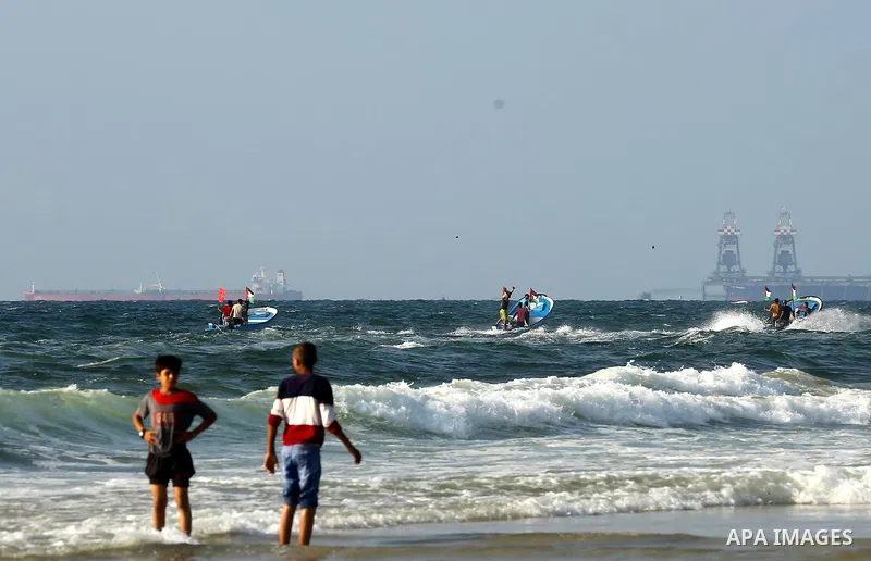 Palestinians ride fishing boats during a rally to break Israel's blockade on Gaza Strip, at the sea in Gaza City, on August 11, 2018. Photo by Dawoud Abo Alkas