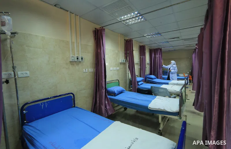A Palestinian nurse checks the beds at al-Rantisi hospital in Gaza City on August 12, 2018. Photo by Mahmoud Khattab