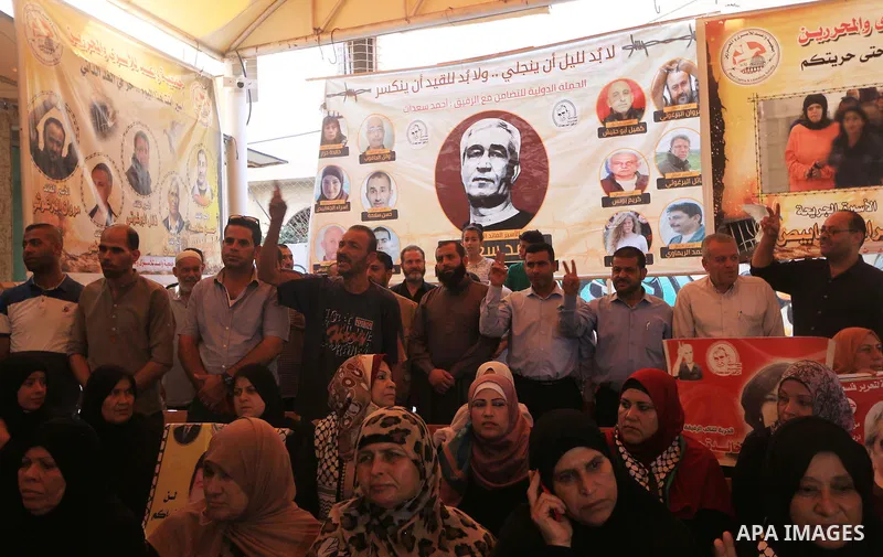 Palestinians take part in a protest to show solidarity with Palestinian prisoners held in Israeli jails, in front of Red cross office in Gaza city on August 13, 2018. Photo by Mahmoud Khattab