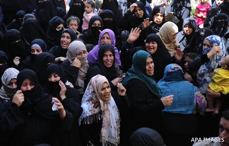 Relatives of Palestinian Wissam Hijazi, who died of wounds he sustained during clashes with Israeli troops, mourn during his funeral, in Khan Younis in the southern of Gaza Strip on August 13, 2018. Photo by Ashraf Amra