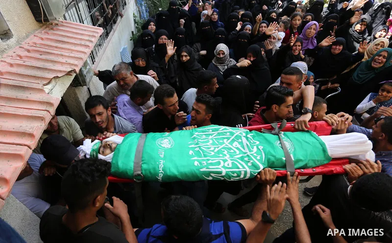 Mourners carry the body of Palestinian Wissam Hijazi, who died of wounds he sustained during clashes with Israeli troops, during his funeral, in Khan Younis in the southern of Gaza Strip on August 13, 2018. Photo by Ashr...