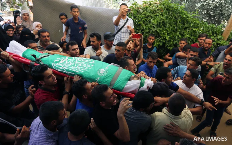 Mourners carry the body of Palestinian Wissam Hijazi, who died of wounds he sustained during clashes with Israeli troops, during his funeral, in Khan Younis in the southern of Gaza Strip on August 13, 2018. Photo by Ashr...