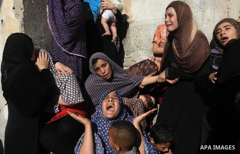 (FILES) This file photo taken on July 16, 2014 shows Relatives of Palestinian children from the Baker family, whom medics said was killed by a shell fired by an Israeli naval gunboat, mourn during their funeral in Gaza C...
