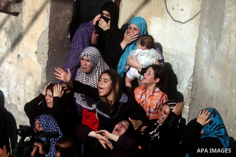 (FILES) This file photo taken on July 16, 2014 shows Relatives of Palestinian children from the Baker family, whom medics said was killed by a shell fired by an Israeli naval gunboat, mourn during their funeral in Gaza C...
