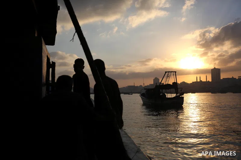 Palestinian fishermen ride their boat, at Gaza seaport, on August 15, 2018. The fishing zone off Gaza's coast was also restored to 17km (nine nautical miles), having been reduced to 6km. Photo by Ashraf Amra