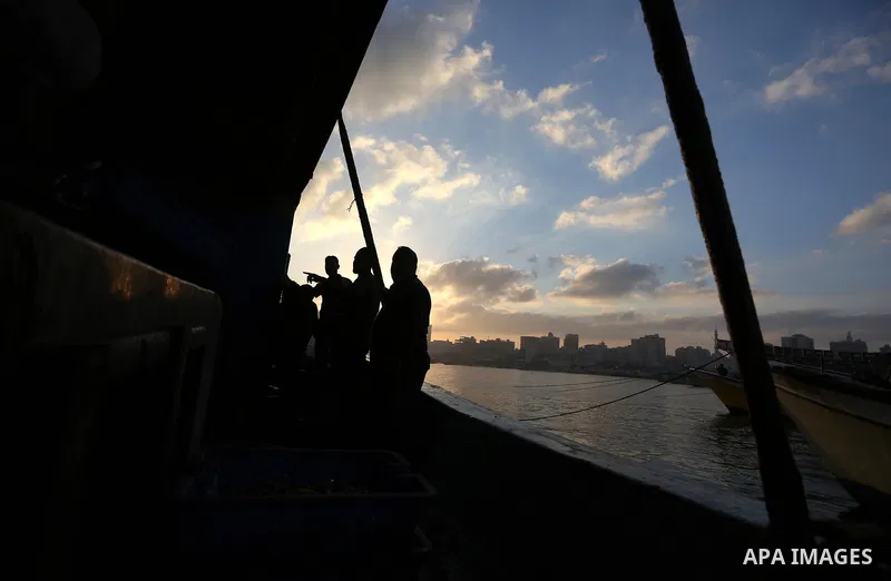 Palestinian fishermen ride their boat, at Gaza seaport, on August 15, 2018. The fishing zone off Gaza's coast was also restored to 17km (nine nautical miles), having been reduced to 6km. Photo by Ashraf Amra