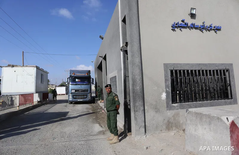 A Palestinian security force stands guard as a fuel tanker arrives at Kerem Shalom crossing in Rafah in the southern Gaza Strip, on August 15, 2018. Israel's defence minister has announced it will reopen the main cargo c...