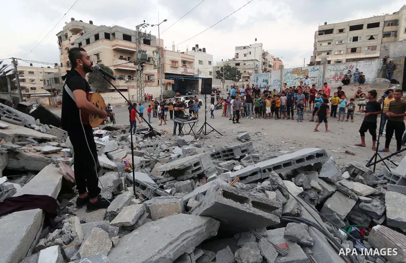 Palestinians attend concert next to the rubble of Said al-Mishal Cultural Center which was destroyed by an Israeli air strike in Gaza city on Aug. 15, 2018. Photo by Mahmoud Khattab