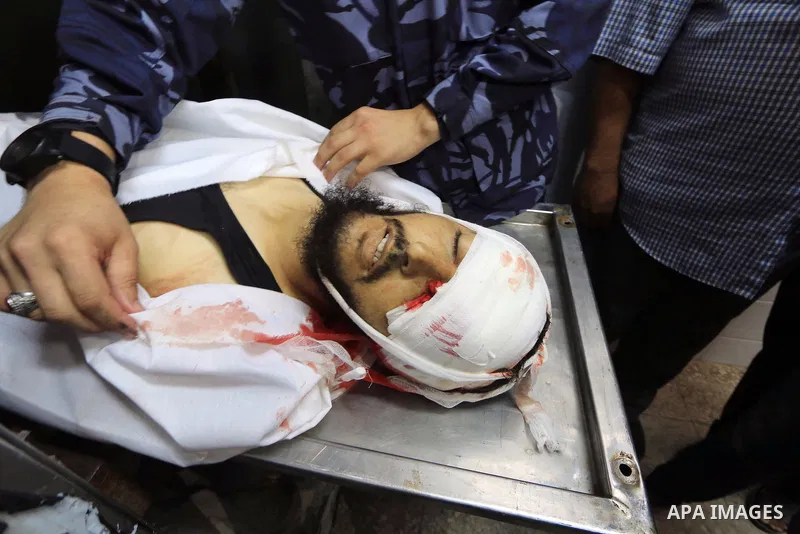 The body of Palestinian Karim Fattair, 30, who was shot dead by Israeli troops during clashes at Gaza-Israel border is seen at the morgue in a hospital, in Deir al-Balah in the center of Gaza Strip on August 17, 2018. Ph...