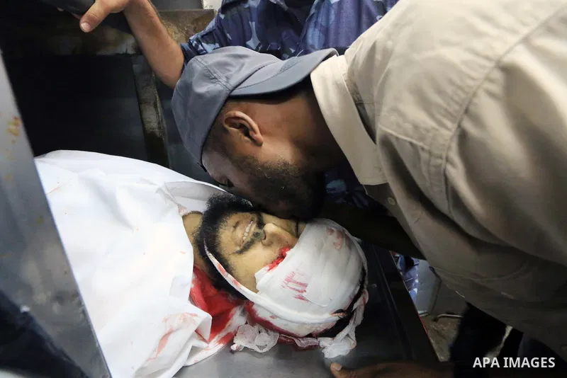 The body of Palestinian Karim Fattair, 30, who was shot dead by Israeli troops during clashes at Gaza-Israel border is seen at the morgue in a hospital, in Deir al-Balah in the center of Gaza Strip on August 17, 2018. Ph...