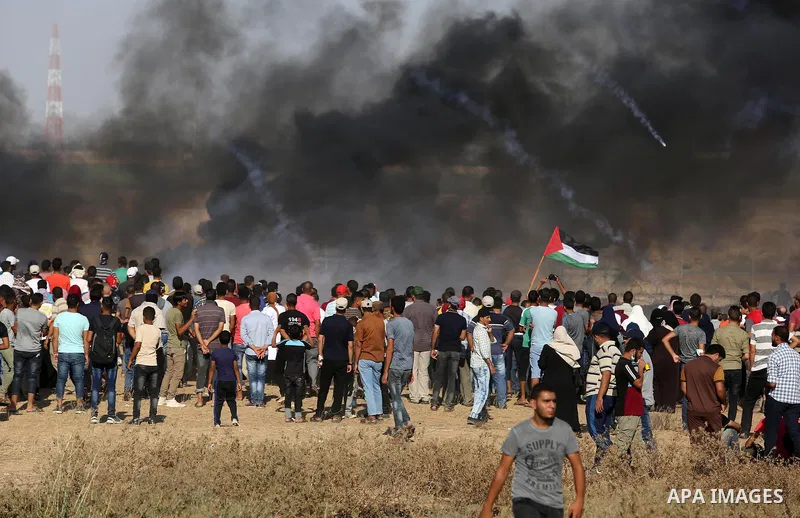 Palestinian protesters gather during clashes with Israeli troops in tents protest where Palestinians demand the right to return to their homeland at the Israel-Gaza border, in Khan Younis in the southern of Gaza Strip on...