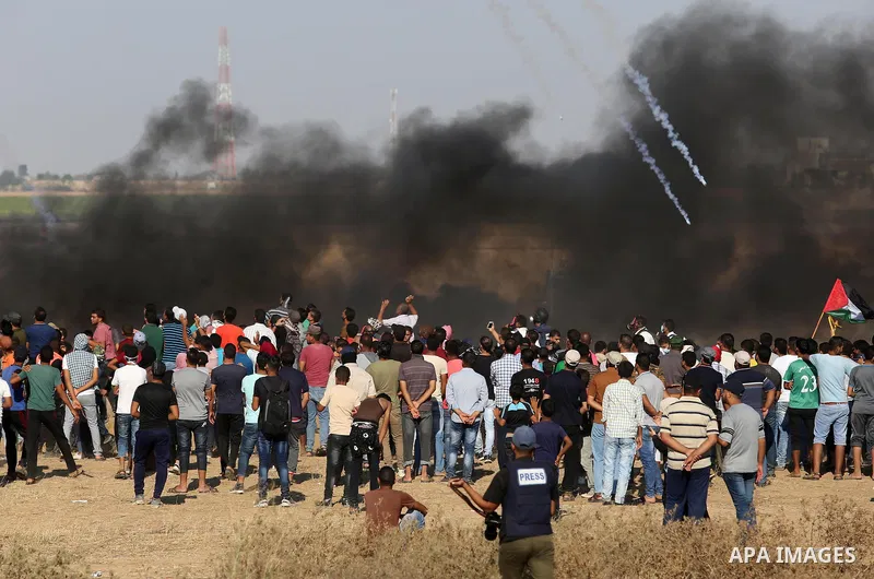 Palestinian protesters gather during clashes with Israeli troops in tents protest where Palestinians demand the right to return to their homeland at the Israel-Gaza border, in Khan Younis in the southern of Gaza Strip on...