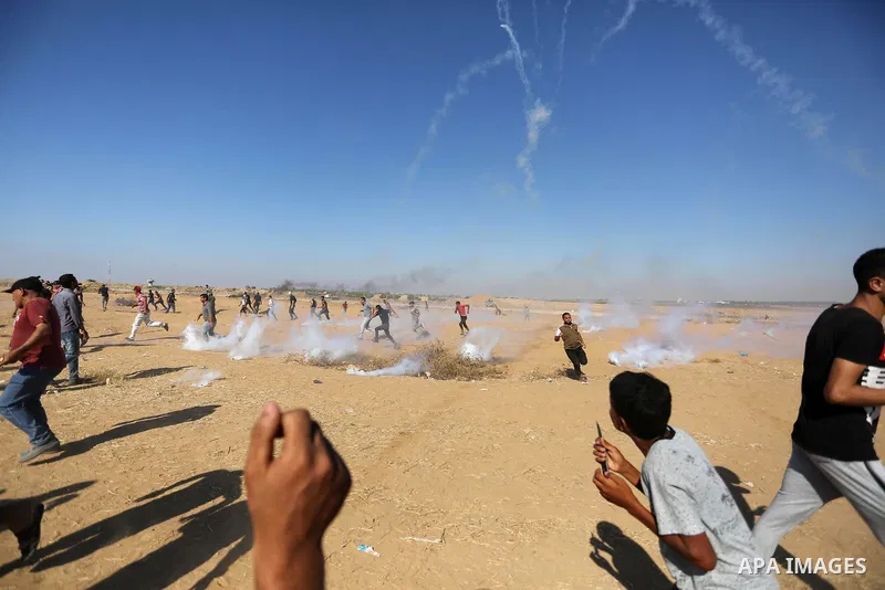 Palestinian protesters gather during clashes with Israeli troops in tents protest where Palestinians demand the right to return to their homeland at the Israel-Gaza border, in Khan Younis in the southern of Gaza Strip on...
