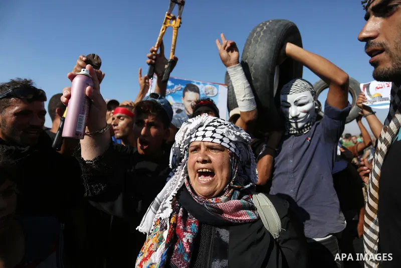 Palestinian protesters gather during clashes with Israeli troops in tents protest where Palestinians demand the right to return to their homeland at the Israel-Gaza border, in Khan Younis in the southern of Gaza Strip on...