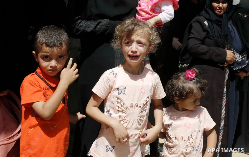 Relatives of Palestinian Sadi Moamer, 26, who was killed by Israeli troops the day before during clashes at Israel-Gaza border, mourn during his funeral in Rafah in the southern Gaza Strip on August 18, 2018. Photo by Ra...
