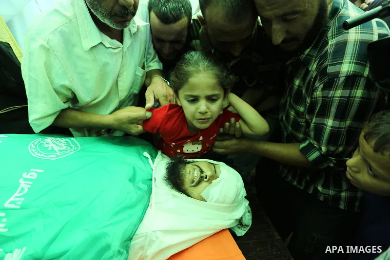 Relatives of Palestinian Karim Abu Fatayer, 30, member of the Islamist movement Hamas' military wing Al-Qassam Brigades who was killed by Israeli troops the day before during clashes at Israel-Gaza border, mourn over his...