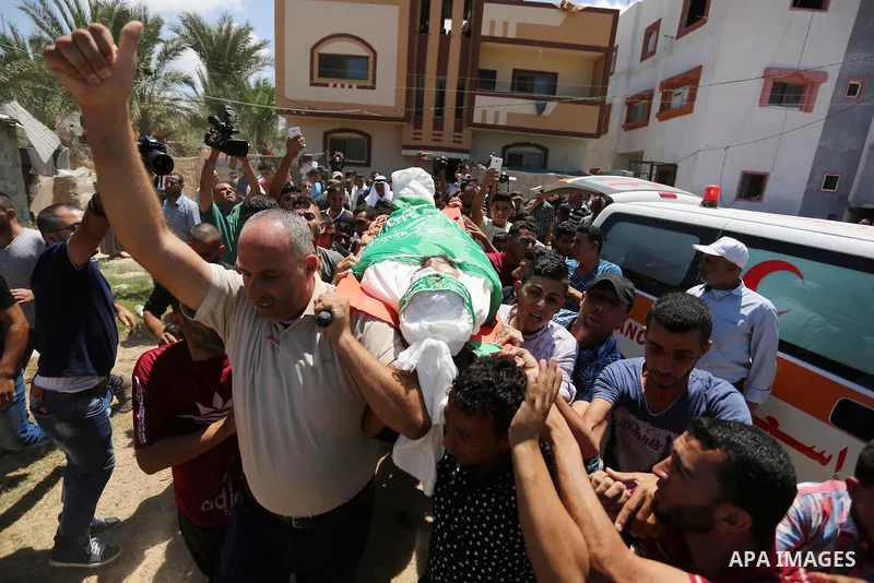 Mourners carry the body of Palestinian Karim Abu Fatayer, 30, member of the Islamist movement Hamas' military wing Al-Qassam Brigades who was killed by Israeli troops the day before during clashes at Israel-Gaza border,...