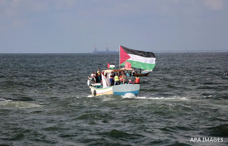 Palestinians ride fishing boats during a rally to break Israel's blockade on Gaza Strip, at the sea in Gaza City, August 18, 2018. Photo by Mahmoud Naser