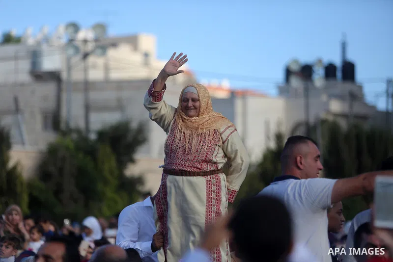 Palestinians celebrate during a mass wedding celebration held under the patronage of Palestinian President Mahmoud Abbas, in the West Bank city of Ramallah on August 18, 2018. Photo by Shadi Hatem