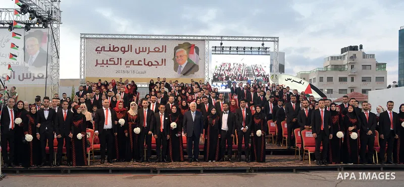 Palestinian couples take part in a mass wedding celebration held under the patronage of Palestinian President Mahmoud Abbas, in the West Bank city of Ramallah on August 18, 2018. Photo by Thaer Ganaim