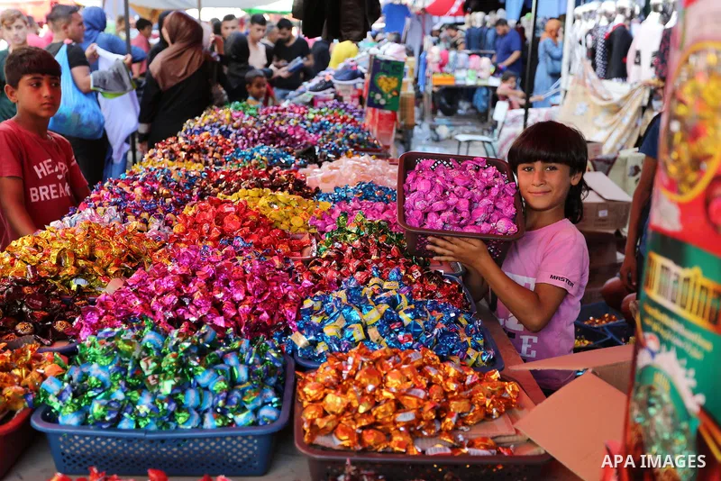Palestinians shop at a market a head of Eid al-Adha in Gaza City on August 19, 2018. Eid al-Adha (the Festival of Sacrifice) is celebrated throughout the Muslim world as a commemoration of Abraham's willingness to sacrif...