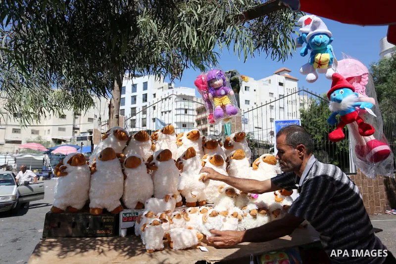 A Palestinian vendor sells toys, a head of Eid al-Adha at a market in Gaza City on August 19, 2018. Eid al-Adha (the Festival of Sacrifice) is celebrated throughout the Muslim world as a commemoration of Abraham's willin...