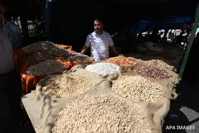 Palestinians shop at a market a head of Eid al-Adha in Gaza City on August 19, 2018. Eid al-Adha (the Festival of Sacrifice) is celebrated throughout the Muslim world as a commemoration of Abraham's willingness to sacrif...