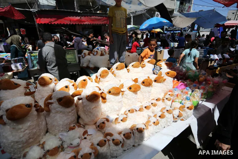 A Palestinian vendor sells toys, a head of Eid al-Adha at a market in Gaza City on August 19, 2018. Eid al-Adha (the Festival of Sacrifice) is celebrated throughout the Muslim world as a commemoration of Abraham's willin...