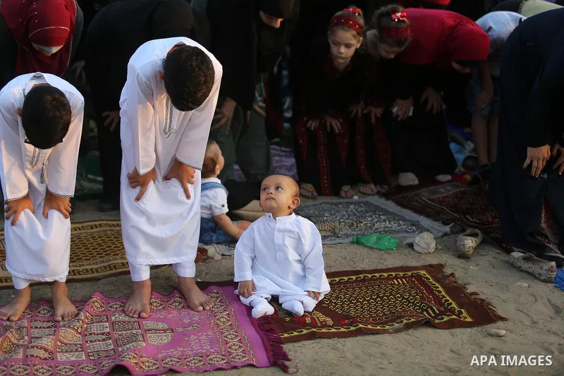 Palestinian muslims perform the prayer of Eid al-Adha or the feast of sacrifice in Gaza city, on August 21, 2018. Muslims around the world are celebrating Eid al-Adha, the "Feast of Sacrifice", which marks the end of the...