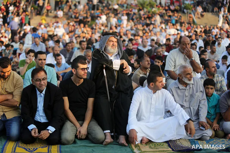 Palestinian muslims perform the prayer of Eid al-Adha or the feast of sacrifice in Gaza city, on August 21, 2018. Muslims around the world are celebrating Eid al-Adha, the "Feast of Sacrifice", which marks the end of the...