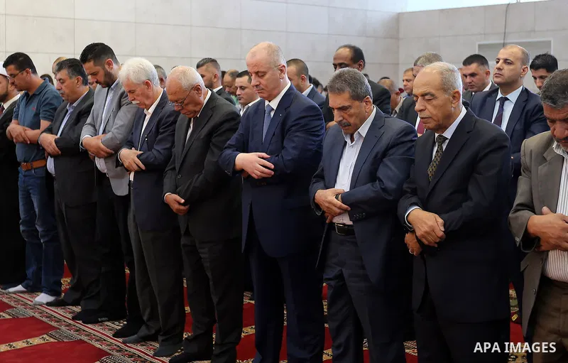 Palestinian Prime Minister Rami Hamdallah performs the prayer of Eid al-Adha or the feast of sacrifice in the West Bank city of Ramallah on August 21, 2018. Muslims around the world are celebrating Eid al-Adha, the "Feas...