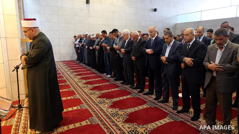 Palestinian Prime Minister Rami Hamdallah performs the prayer of Eid al-Adha or the feast of sacrifice in the West Bank city of Ramallah on August 21, 2018. Muslims around the world are celebrating Eid al-Adha, the "Feas...