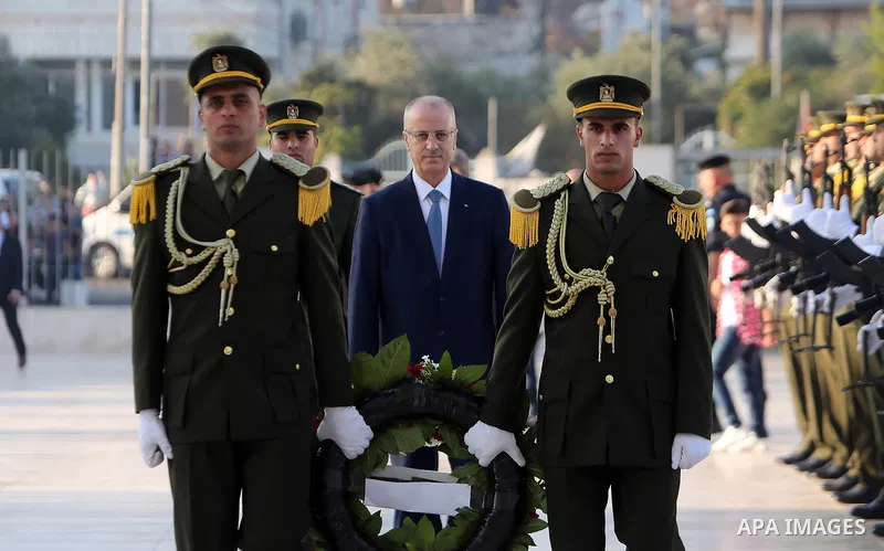 Palestinian Prime Minister Rami Hamdallah lays a wreath on the grave of late Palestinian leader Yasser Arafat on the first day of Eid al-Adha or the feast of sacrifice in the West Bank city of Ramallah on August 21, 2018...
