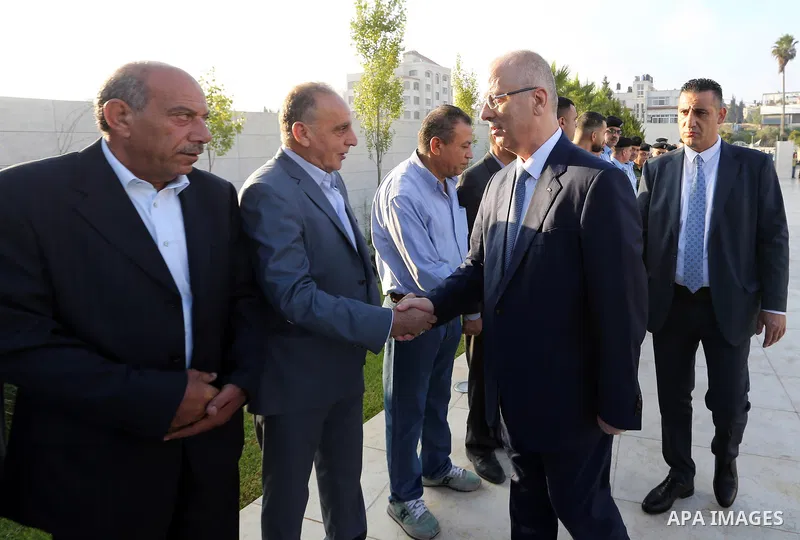 Palestinian Prime Minister Rami Hamdallah performs the prayer of Eid al-Adha or the feast of sacrifice in the West Bank city of Ramallah on August 21, 2018. Muslims around the world are celebrating Eid al-Adha, the "Feas...