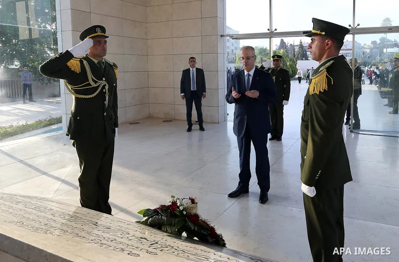Palestinian Prime Minister Rami Hamdallah lays a wreath on the grave of late Palestinian leader Yasser Arafat on the first day of Eid al-Adha or the feast of sacrifice in the West Bank city of Ramallah on August 21, 2018...