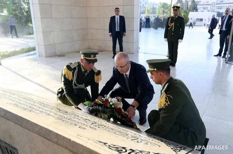 Palestinian Prime Minister Rami Hamdallah lays a wreath on the grave of late Palestinian leader Yasser Arafat on the first day of Eid al-Adha or the feast of sacrifice in the West Bank city of Ramallah on August 21, 2018...
