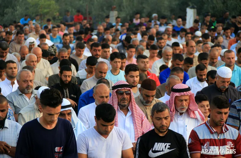 Palestinian muslims perform the prayer of Eid al-Adha or the feast of sacrifice, in al-Bureij refugee camp in the center of Gaza Strip, on August 21, 2018. Muslims around the world are celebrating Eid al-Adha, the "Feast...
