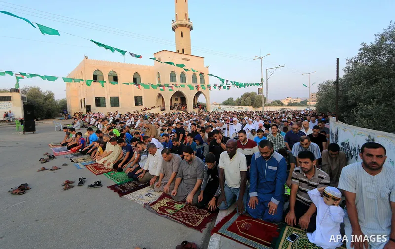 Palestinian muslims perform the prayer of Eid al-Adha or the feast of sacrifice, in al-Bureij refugee camp in the center of Gaza Strip, on August 21, 2018. Muslims around the world are celebrating Eid al-Adha, the "Feast...