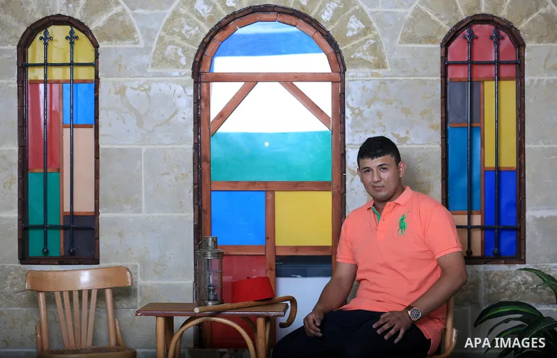 A Palestinian youth poses for a photo during a photoshoot on the second day of Eid al-Adha or the feast of sacrifice, in the West Bank city of Nablus on August 22, 2018. Photo by Shadi Jarar'ah