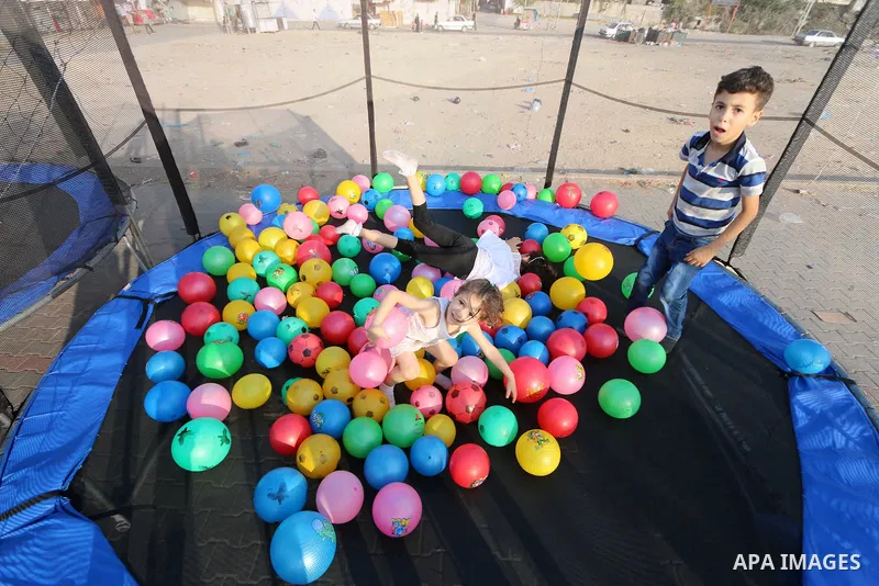 Palestinian children enjoy their time on the third day of Eid al-Adha or feast of the sacrifice, in al-Nusairat in the center of Gaza Strip on August 23, 2018. Muslims around the world are celebrating Eid al-Adha, the "F...