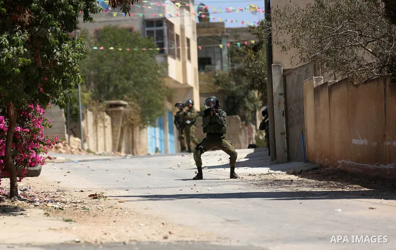 Israeli forces take position during clashes with Palestinian protesters following a weekly demonstration against the expropriation of Palestinian land by Israel in the village of Kfar Qaddum, near the West Bank city of N...