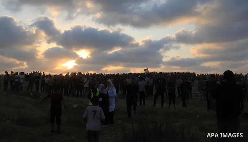 Palestinian protesters gather during clashes with Israeli troops in tents protest where Palestinians demand the right to return to their homeland at the Israel-Gaza border, in al-Bureij in the center of Gaza Strip on Aug...