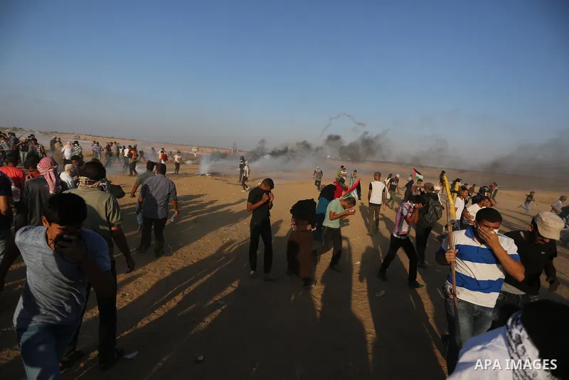 Palestinian protesters gather during clashes with Israeli troops in tents protest where Palestinians demand the right to return to their homeland at the Israel-Gaza border, in Khan Younis in the southern of Gaza Strip on...
