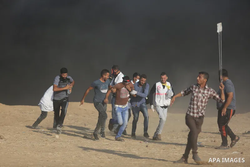 Palestinian protesters gather during clashes with Israeli troops in tents protest where Palestinians demand the right to return to their homeland at the Israel-Gaza border, in Khan Younis in the southern of Gaza Strip on...