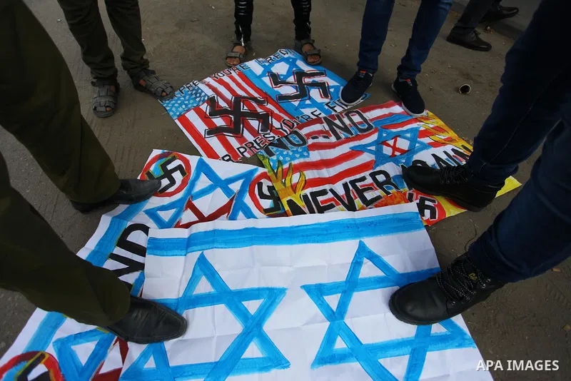Palestinians burn an Israeli, British and U.S. flags during a protest to show solidarity with Palestinian prisoners held in Israeli jails, in front of Red cross office in Gaza city on August 27, 2018. Photo by Mahmoud Aj...